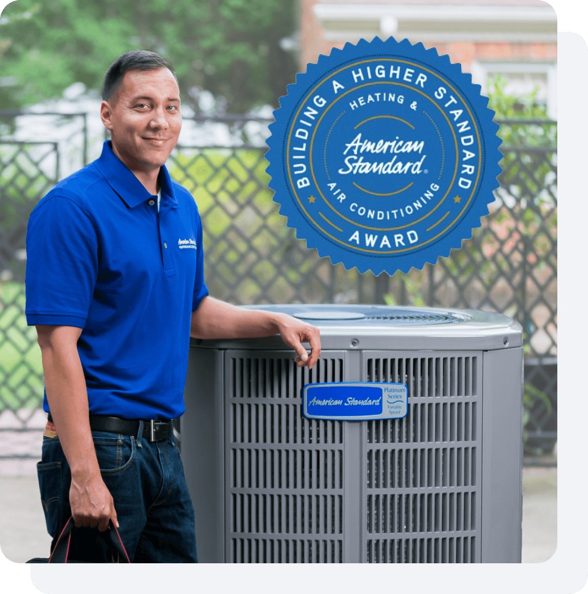 An American Standard Heating & Air Conditioning dealer standing by an outdoor HVAC unit.