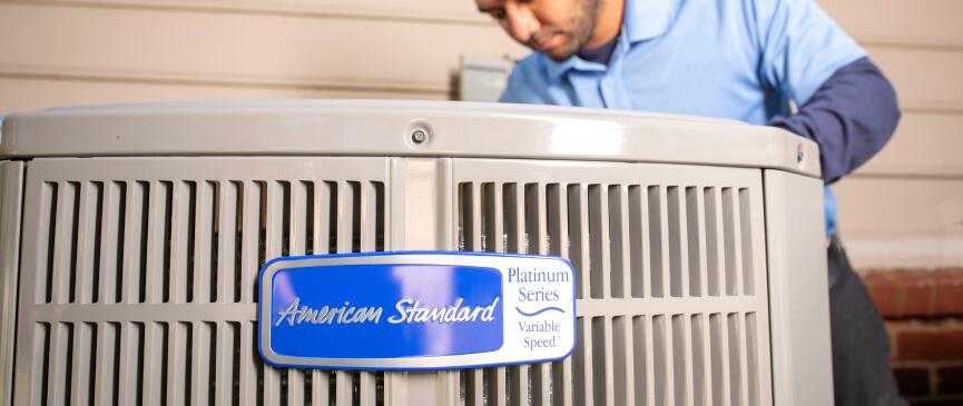 An HVAC technician works on an American Standard Platinum Series Variable Speed system.