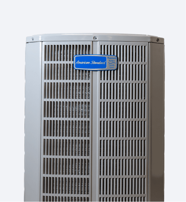 A gray-coloredAmerican Standard air conditioner unit with a blue logo.