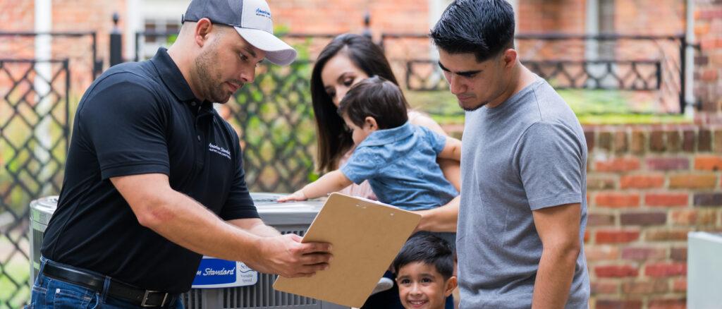 A family looking at a checklist with their HVAC dealer