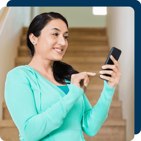 A woman researching HVAC systems on her mobile phone.