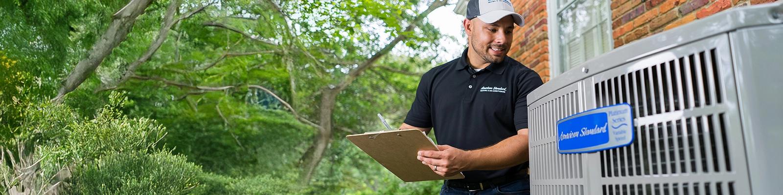 HVAC Technician with American Standard AC Unit