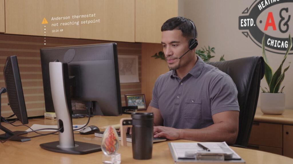 An ASA home technician is seated at his desk.